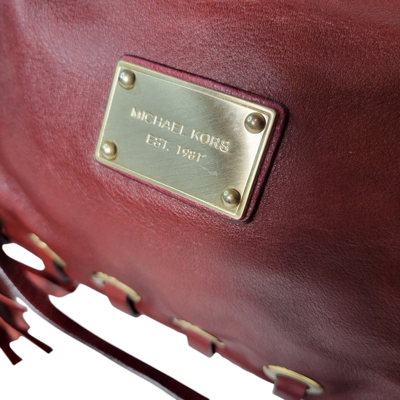 Michael Kors red leather clutch with grommets and tassels